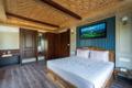 Carved walnut bed in a Super Deluxe bedroom