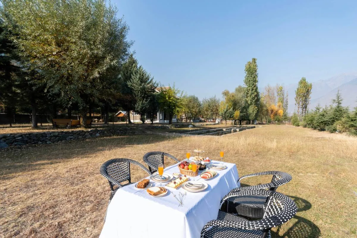 Kashmiri breakfast on the lawn at Khwab Villa, Kangan, Kashmir Breakfast table set on the lawn at Khwab Villa with mountains behind
