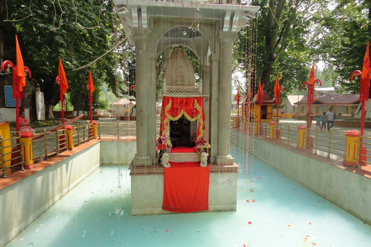 Marble shrine of Goddess Ragnya Devi in the middle of the sacred spring at Kheer Bhawani Temple, Tulmulla, with saffron flags and chinar trees around it | Khwab Villa, Kangan, Kashmir Marble shrine of Goddess Ragnya Devi in the middle of the sacred spring at Kheer Bhawani Temple, Tulmulla, with saffron flags and chinar trees around it