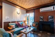Living room with fireplace and teal sofas